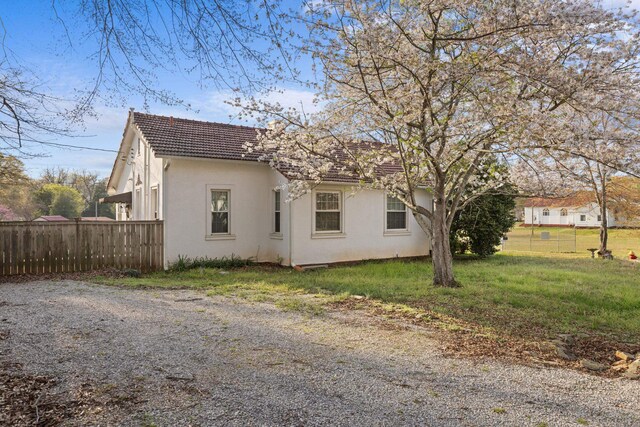  - view of home's exterior with stucco siding and a tiled roof