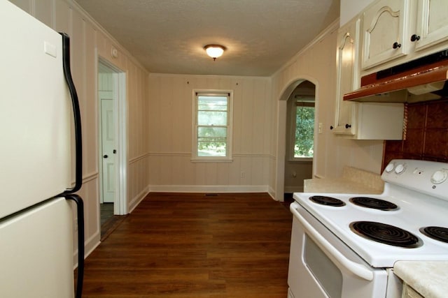 kitchen featuring a textured ceiling, dark wood-type flooring, white appliances, and ornamental molding