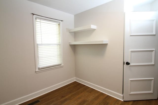 clothes washing area with dark hardwood / wood-style flooring