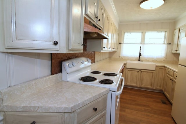 kitchen featuring sink, light brown cabinets, crown molding, white appliances, and hardwood / wood-style flooring