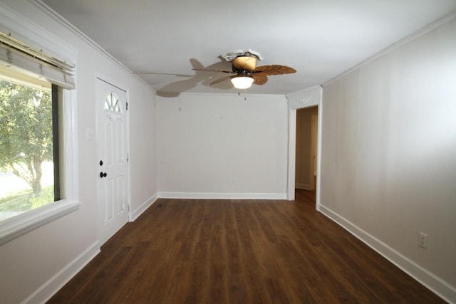 spare room with ceiling fan, dark hardwood / wood-style flooring, and crown molding