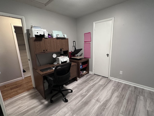 office space with a textured ceiling and light wood-type flooring