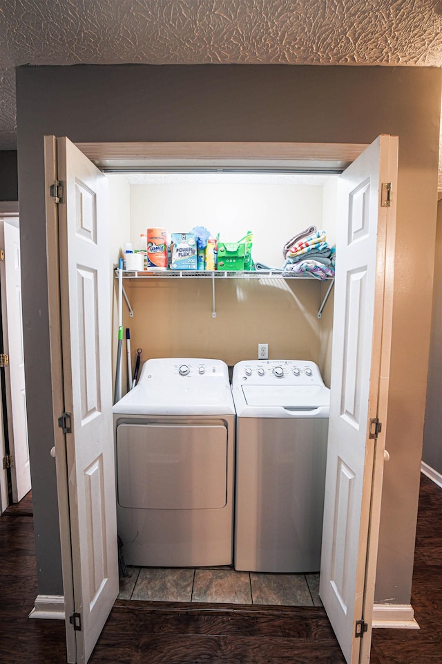 laundry room with washer and dryer and tile patterned flooring