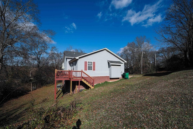 back of property featuring a lawn and a deck