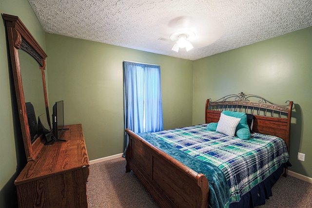 carpeted bedroom featuring ceiling fan and a textured ceiling