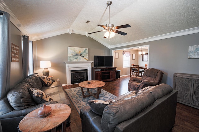 living room featuring lofted ceiling, dark wood-type flooring, ceiling fan, ornamental molding, and a textured ceiling