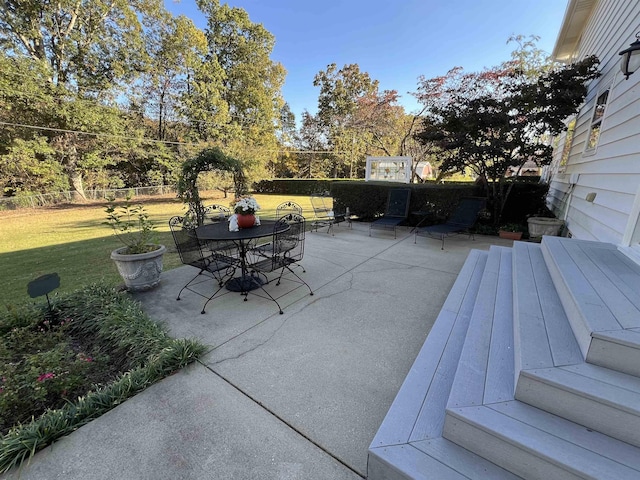 view of patio featuring outdoor dining area and fence