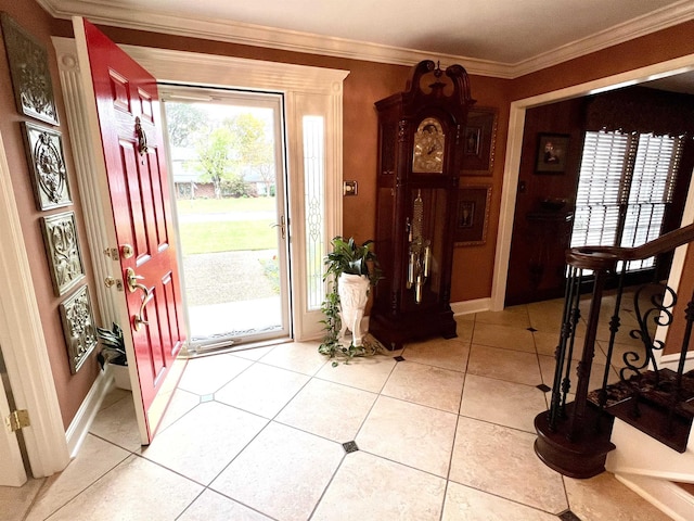 foyer entrance featuring ornamental molding, light tile patterned floors, baseboards, and stairs