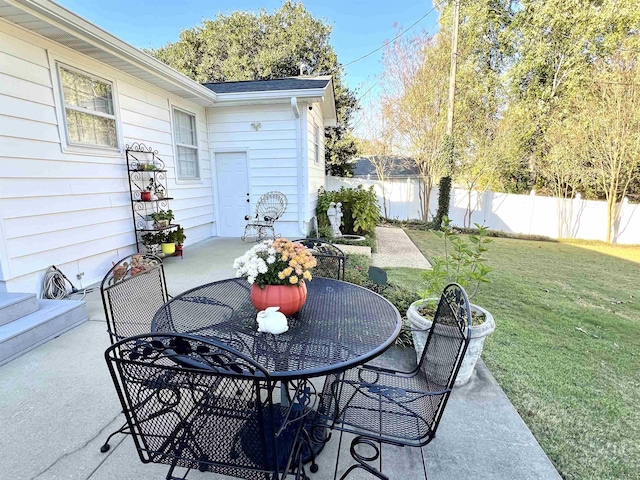 view of patio featuring fence and outdoor dining area