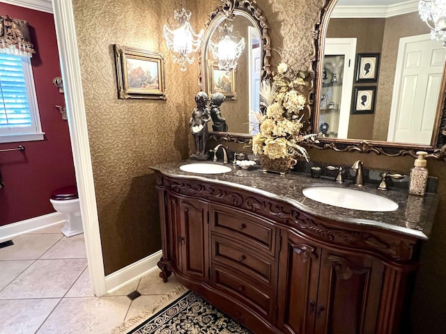 bathroom with crown molding, double vanity, a sink, and tile patterned floors