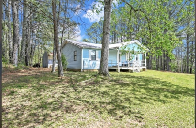 exterior space featuring a wooden deck and a front lawn