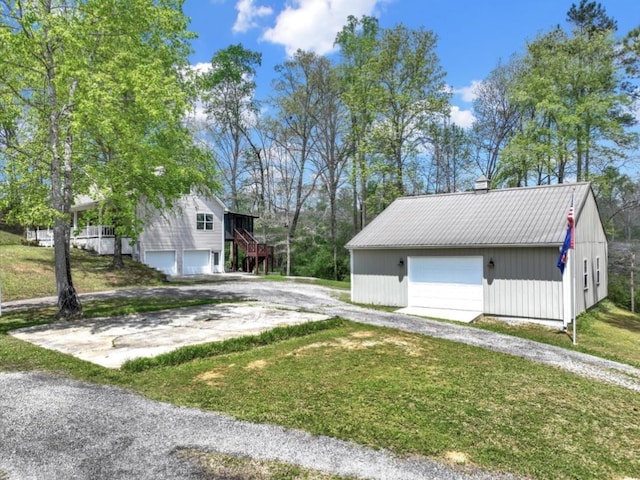 view of property exterior with a garage and a lawn