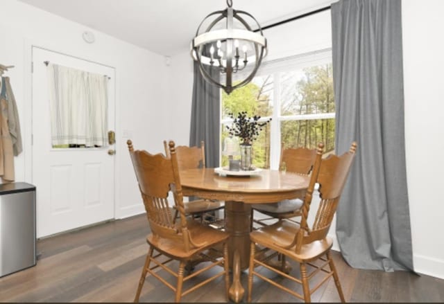 dining room with a chandelier and dark wood-type flooring