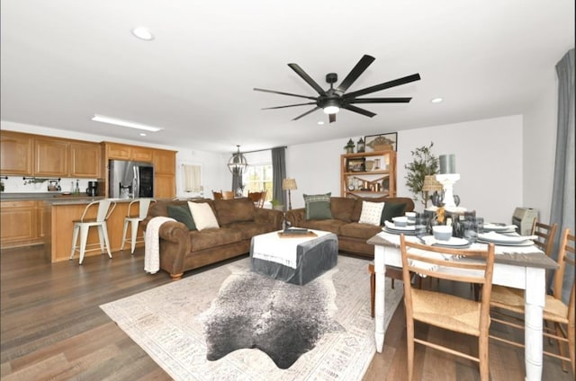 living room with ceiling fan and dark wood-type flooring