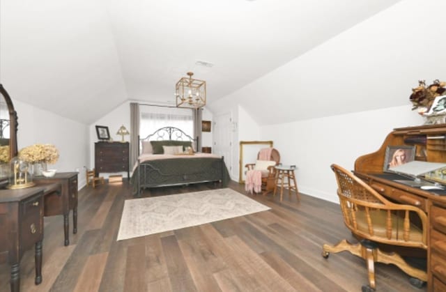 bedroom featuring dark hardwood / wood-style flooring, an inviting chandelier, and lofted ceiling