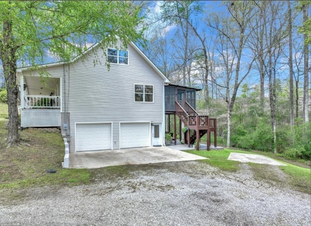 view of side of home with a sunroom and a garage