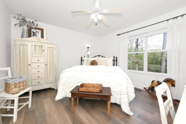 bedroom with ceiling fan and dark hardwood / wood-style floors