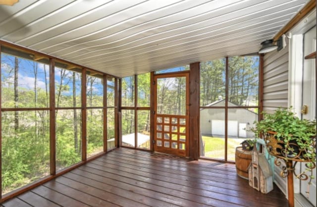 unfurnished sunroom with lofted ceiling