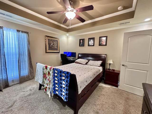  - bedroom with a tray ceiling, carpet, crown molding, and ceiling fan