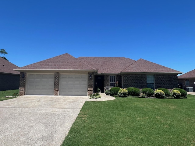 - single story home with an attached garage, driveway, a front lawn, and brick siding