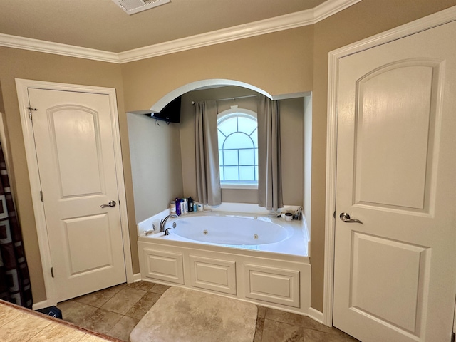 - bathroom featuring crown molding, a tub with jets, and tile patterned flooring