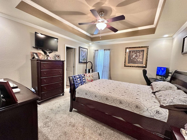  - bedroom with a tray ceiling, crown molding, carpet flooring, a textured wall, and a ceiling fan
