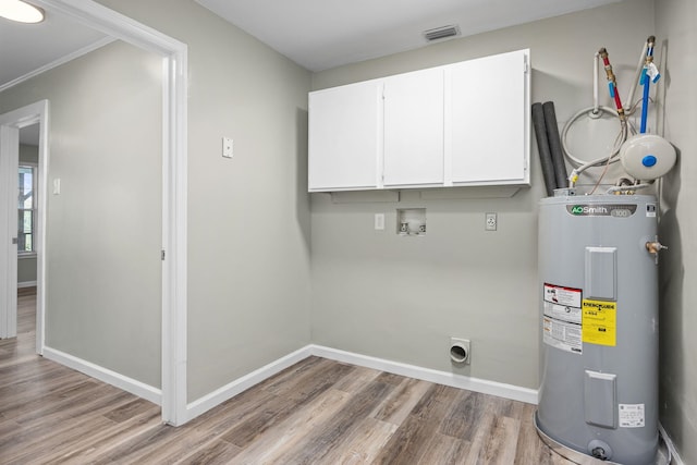 laundry room featuring cabinets, hookup for an electric dryer, water heater, hookup for a washing machine, and hardwood / wood-style flooring