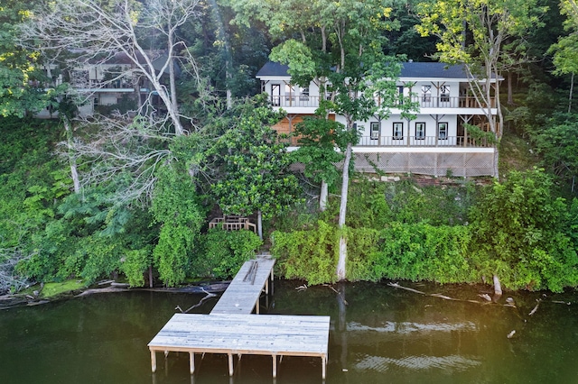 dock area featuring a balcony and a water view