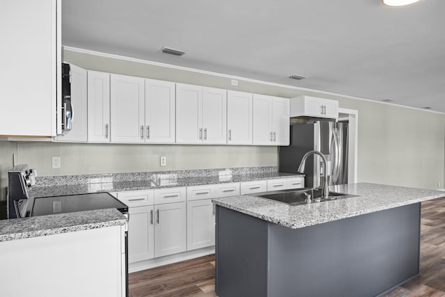 kitchen with white cabinets and an island with sink