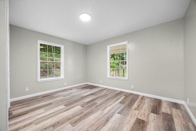 unfurnished room with light hardwood / wood-style floors