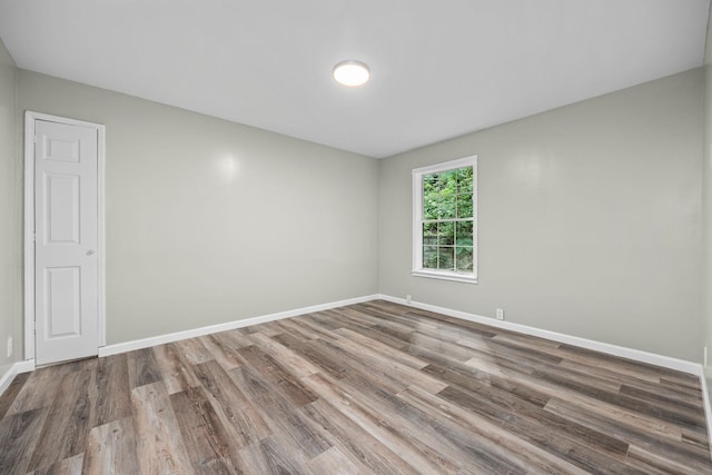 unfurnished room with wood-type flooring