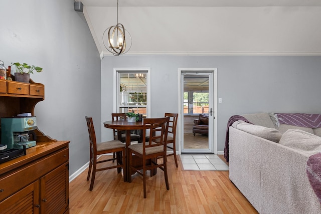  - dining room featuring light wood-type flooring, a chandelier, lofted ceiling, crown molding, and baseboards