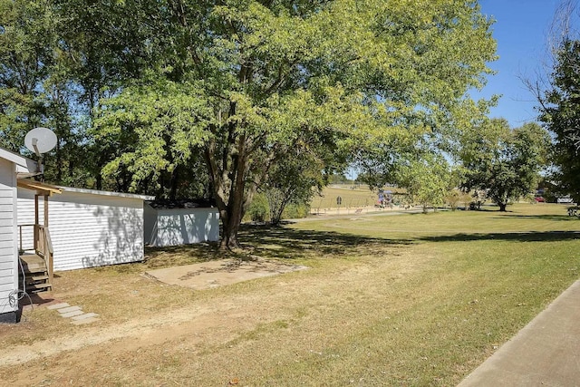  - view of grassy yard with entry steps
