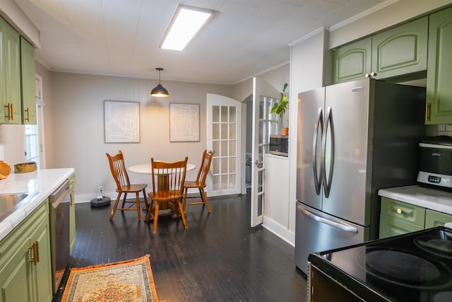  - kitchen featuring green cabinets, dark wood finished floors, appliances with stainless steel finishes, light countertops, and crown molding