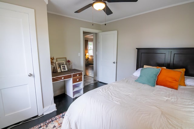  - bedroom featuring dark wood-style flooring, crown molding, and a ceiling fan