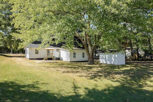  - view of green lawn featuring a storage unit