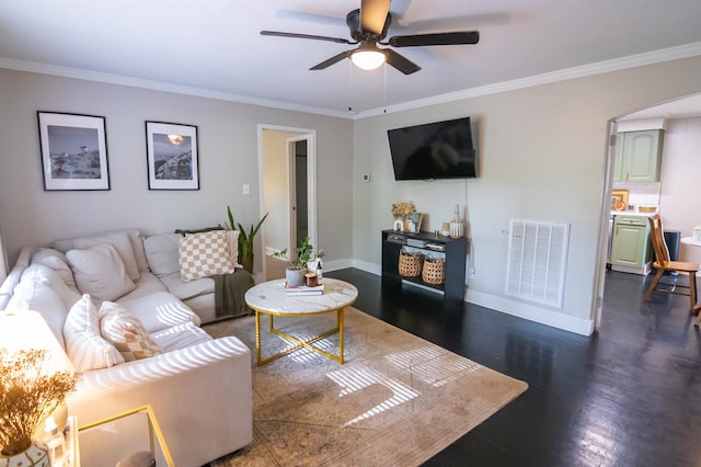  - living room featuring ceiling fan, arched walkways, ornamental molding, and dark wood-style flooring