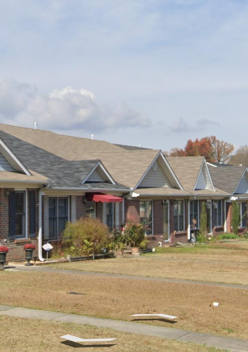 view of front of home with brick siding and a front lawn