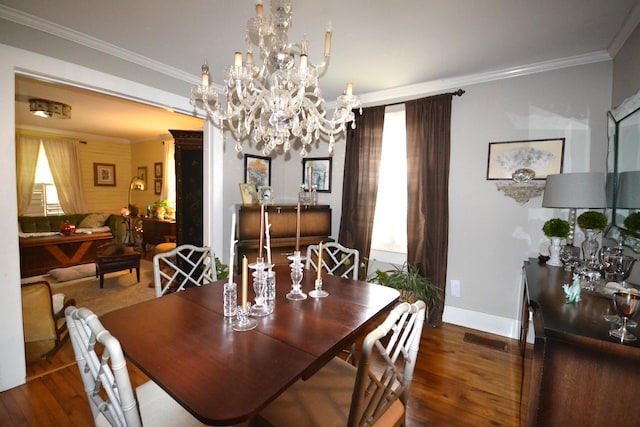 dining room with ornamental molding, dark wood-type flooring, and a notable chandelier