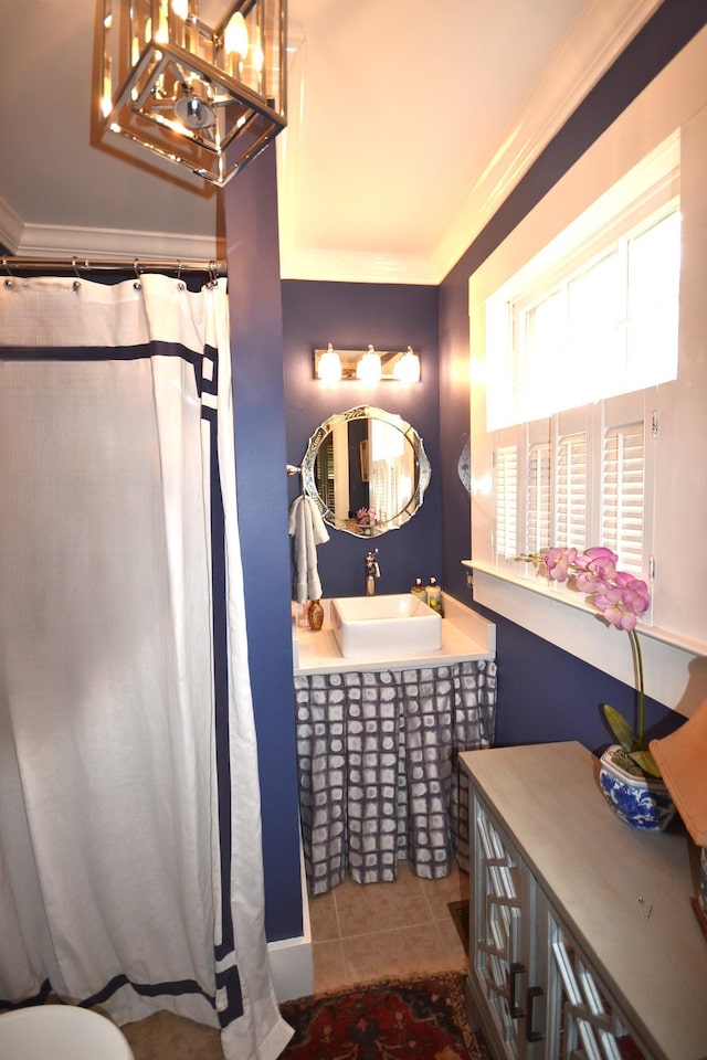 bathroom featuring ornamental molding, tile patterned floors, and sink