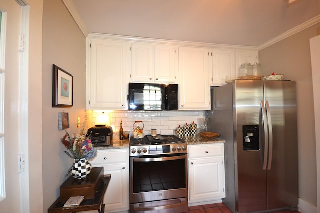 kitchen with backsplash, dark stone counters, white cabinets, and appliances with stainless steel finishes