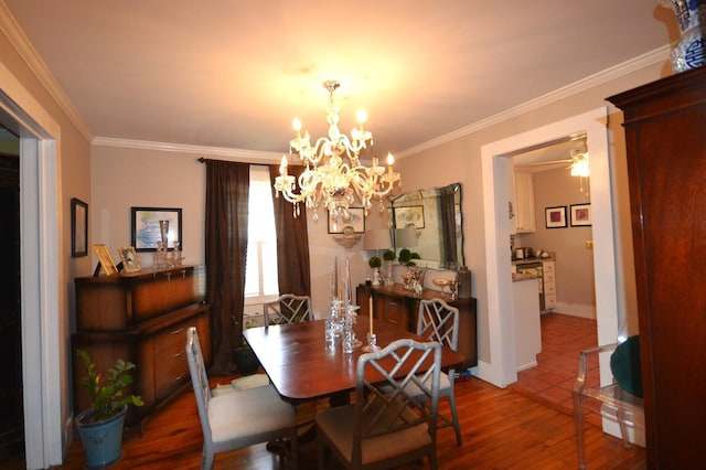 dining room with hardwood / wood-style flooring, ornamental molding, and a chandelier