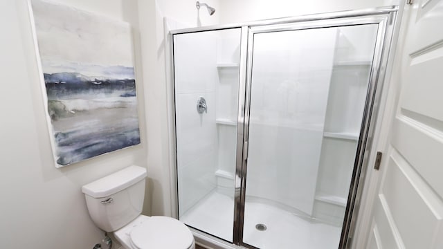  - bathroom featuring a shower stall and toilet