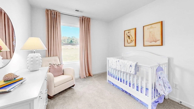  - bedroom featuring light colored carpet, a nursery area, and baseboards