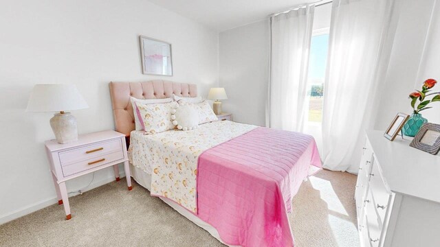  - bedroom featuring light carpet