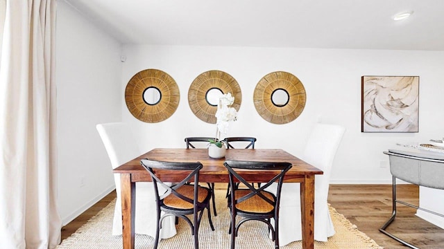  - dining space with wood finished floors and baseboards