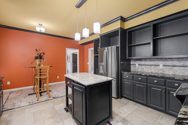  - kitchen featuring open shelves, stainless steel fridge, dark cabinets, a kitchen island, and dark stone countertops