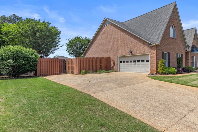  - view of home's exterior featuring brick siding, concrete driveway, roof with shingles, and an attached garage