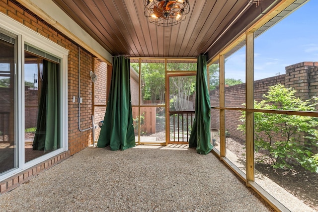 - unfurnished sunroom with a chandelier