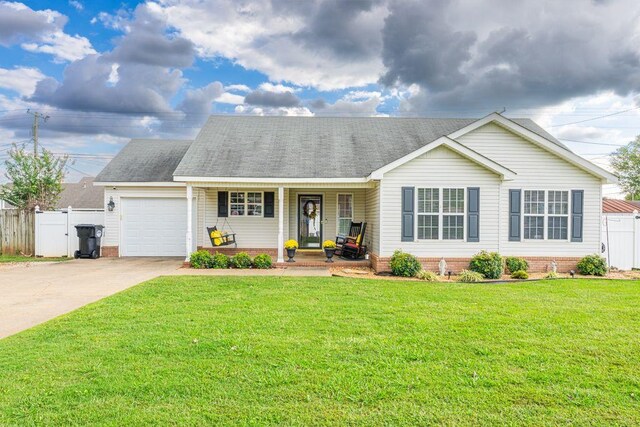 view of front of house with a front yard, a porch, and a garage